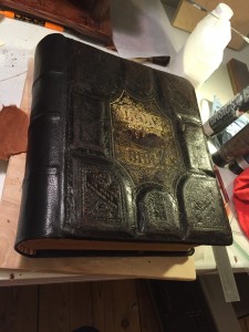 The Bible with new spine attached, just after repairing, toning, and treating the leather. 